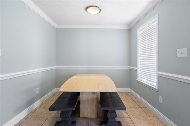 tiled dining room featuring crown molding