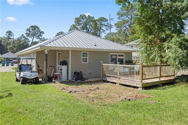 back of property with a lawn and a deck