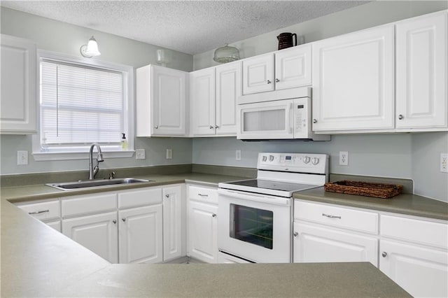 kitchen with a textured ceiling, white appliances, white cabinetry, and sink