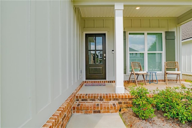 view of exterior entry featuring covered porch