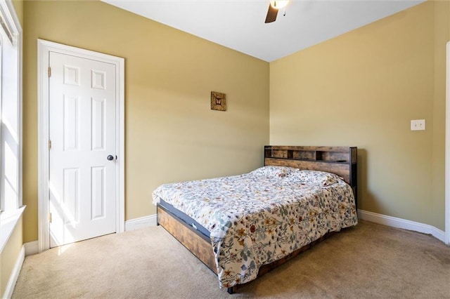 carpeted bedroom with baseboards and ceiling fan