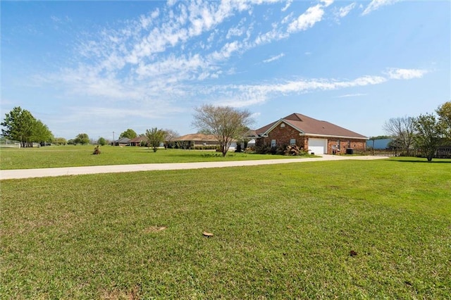 view of yard with driveway and a garage