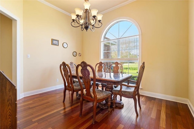 dining space featuring ornamental molding, a notable chandelier, dark wood-type flooring, and baseboards