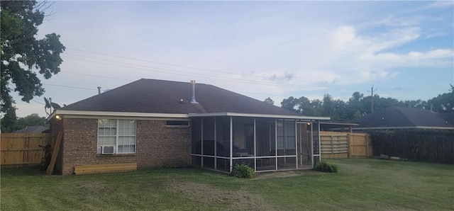 13556 James Copeland Dr, Mobile, AL 36695 - rear view of house with a fenced backyard, brick siding, and a sunroom