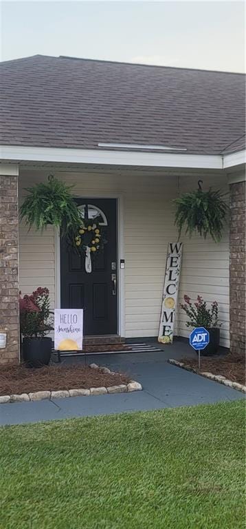 13556 James Copeland Dr, Mobile, AL 36695 - view of exterior entry with a shingled roof