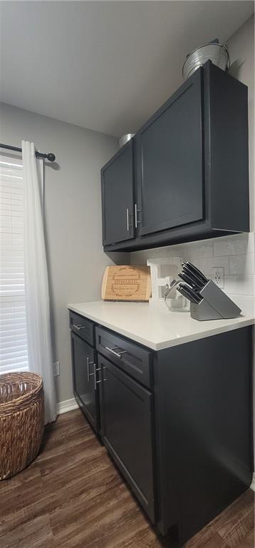 13556 James Copeland Dr, Mobile, AL 36695 - bar with dark wood-style flooring and backsplash