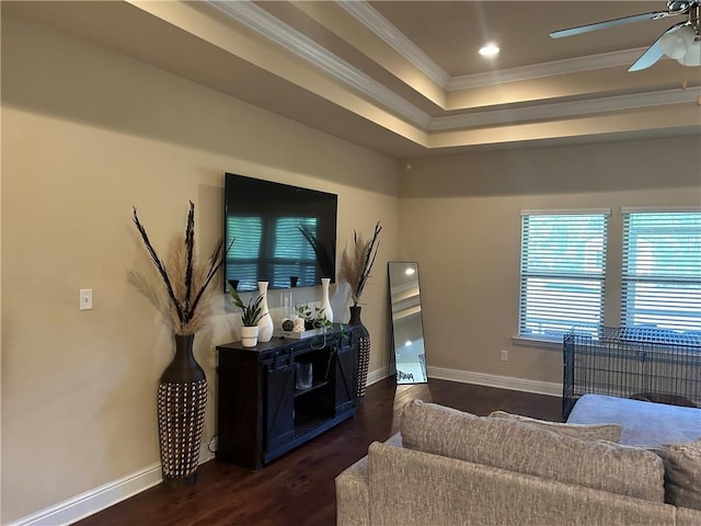 living room with ceiling fan, baseboards, dark wood-type flooring, and crown molding