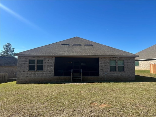 back of property with brick siding, a lawn, and a shingled roof