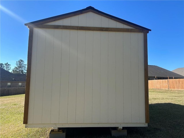 view of shed featuring fence