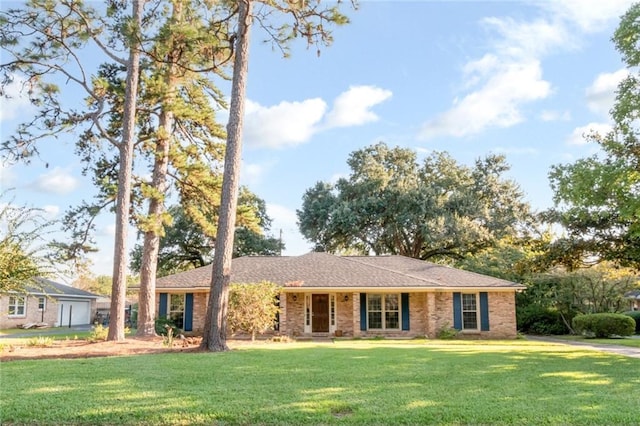 ranch-style home featuring a front yard and brick siding