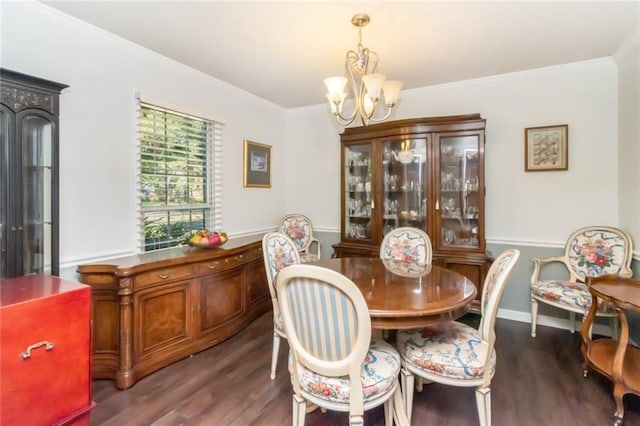 dining space with crown molding, wood finished floors, and a notable chandelier