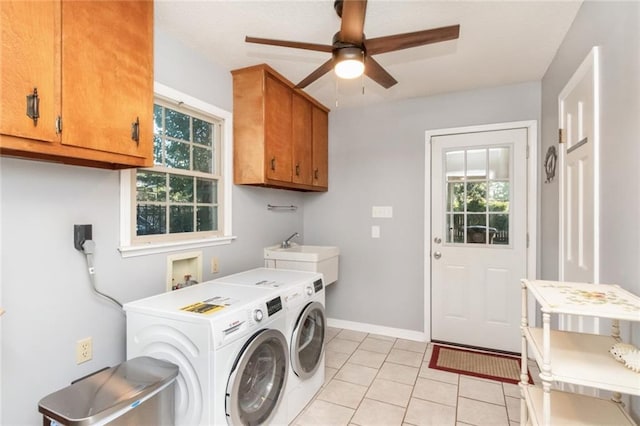 laundry room with plenty of natural light, light tile patterned floors, ceiling fan, and cabinet space