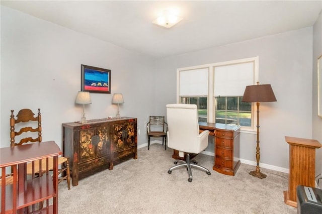 carpeted office space featuring baseboards