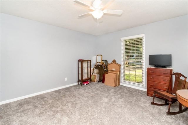 sitting room with carpet, baseboards, and a ceiling fan