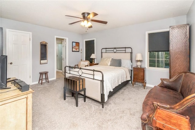 bedroom with baseboards, ceiling fan, and light carpet
