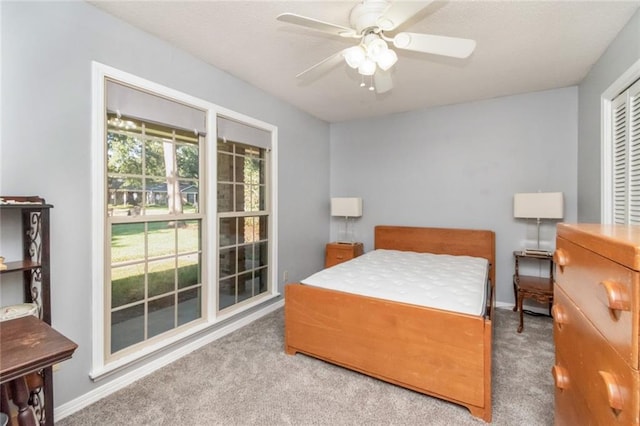 carpeted bedroom featuring ceiling fan and baseboards