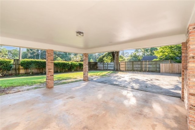 view of patio featuring a carport and a fenced backyard
