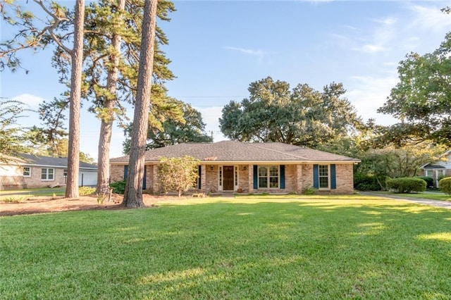 single story home featuring a front yard and brick siding