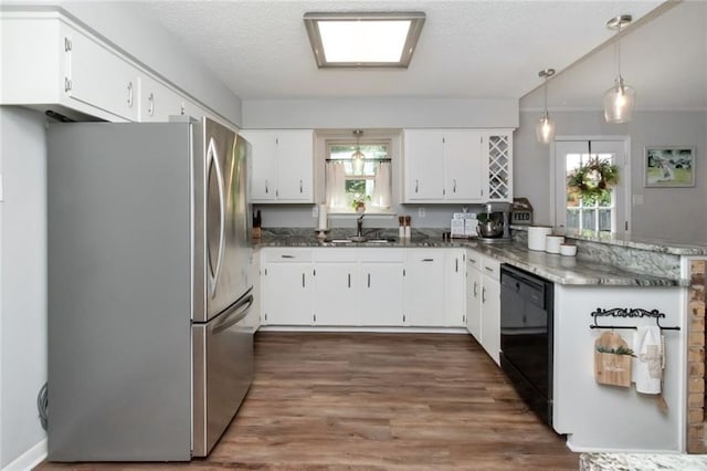 kitchen with stainless steel refrigerator, sink, white cabinets, and black dishwasher