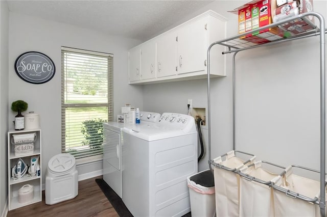 laundry room with cabinets, dark hardwood / wood-style floors, a wealth of natural light, and washing machine and clothes dryer