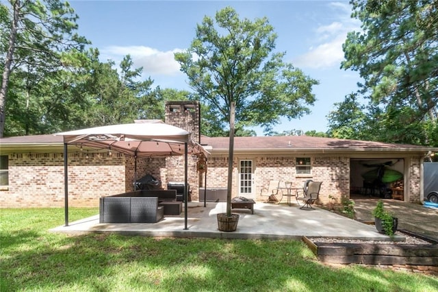 rear view of house with a lawn, a patio area, and an outdoor living space