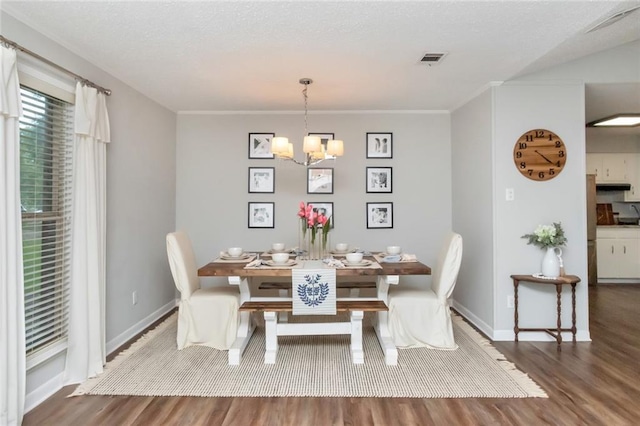 dining area with a chandelier and wood-type flooring