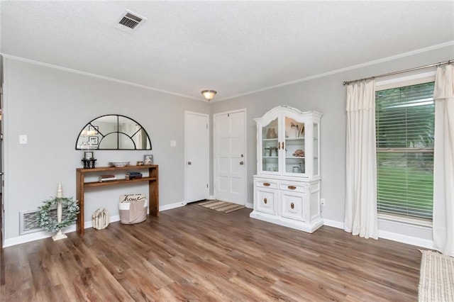 entryway with crown molding and dark hardwood / wood-style floors