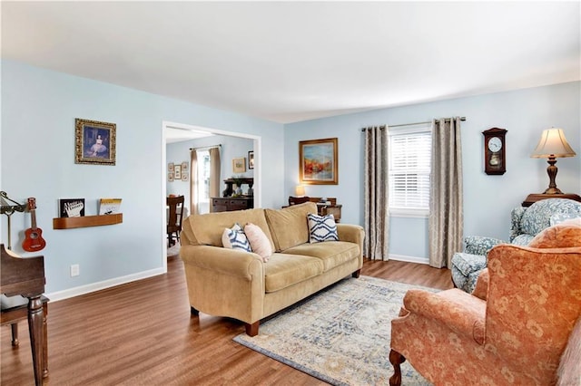 living area featuring baseboards and wood finished floors
