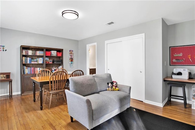 sitting room featuring visible vents, wood finished floors, and baseboards