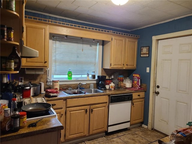 kitchen with a sink, ornamental molding, dark countertops, and white dishwasher