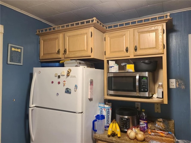 kitchen featuring freestanding refrigerator and stainless steel microwave