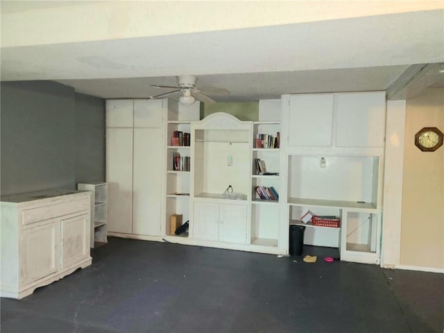basement featuring ceiling fan and baseboards
