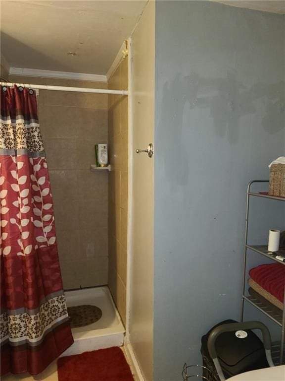bathroom with a shower stall and ornamental molding