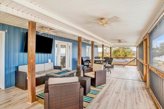 sunroom featuring ceiling fan and wooden ceiling