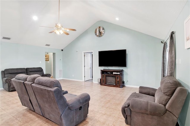 living room featuring ceiling fan, a fireplace, high vaulted ceiling, and light tile patterned floors