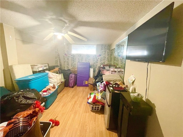 additional living space featuring a textured ceiling, light hardwood / wood-style floors, and ceiling fan