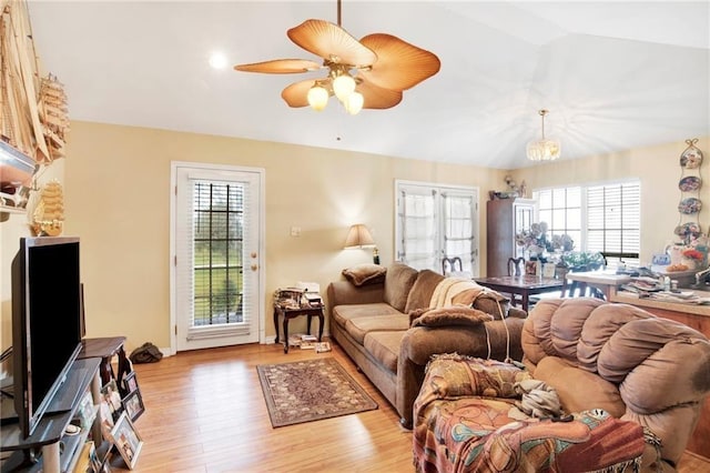 living room featuring lofted ceiling, ceiling fan, and light wood-type flooring