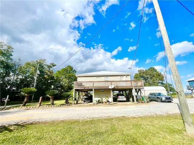 view of car parking with stairway, driveway, and a carport