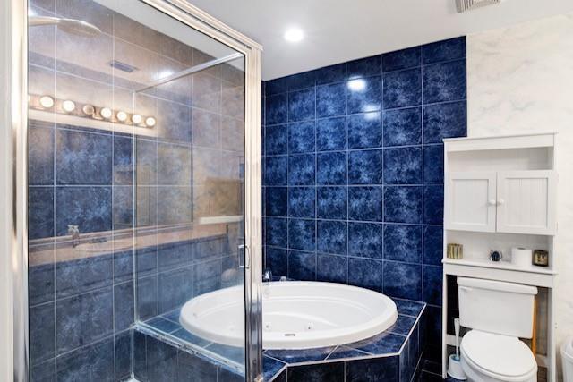 bathroom featuring independent shower and bath, tile walls, and toilet