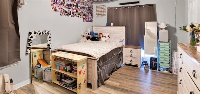bedroom with wood finished floors