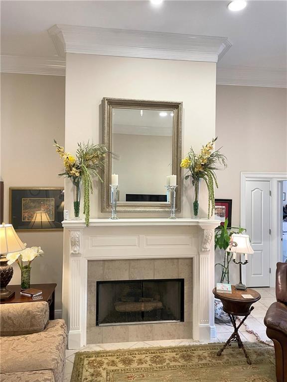 9849 Aspen Cir, Daphne, AL 36527 - detailed view of crown molding, a tiled fireplace, and recessed lighting