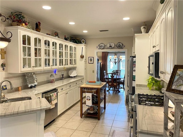 9849 Aspen Cir, Daphne, AL 36527 - kitchen with appliances with stainless steel finishes, tasteful backsplash, glass insert cabinets, light tile patterned flooring, and crown molding