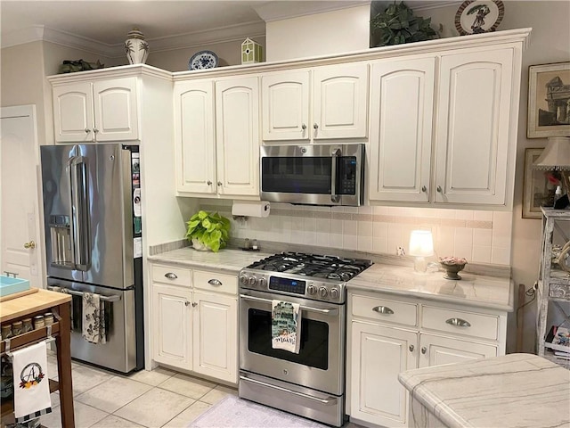 9849 Aspen Cir, Daphne, AL 36527 - kitchen featuring stainless steel appliances, light countertops, backsplash, crown molding, and light tile patterned floors
