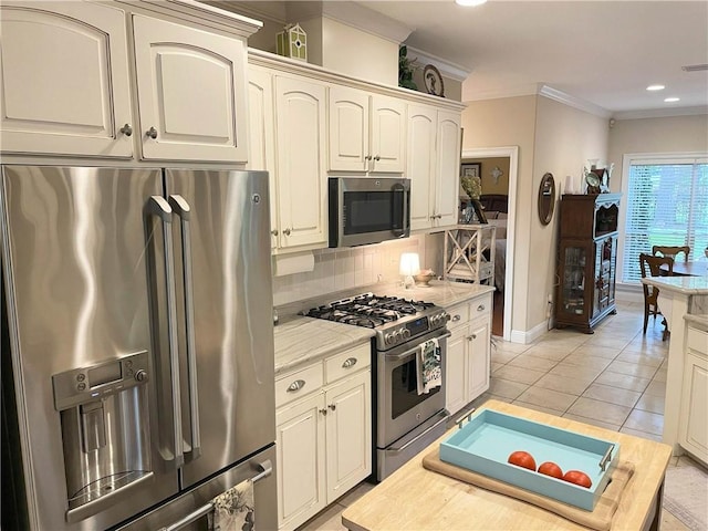 9849 Aspen Cir, Daphne, AL 36527 - kitchen with stainless steel appliances, tasteful backsplash, ornamental molding, light tile patterned flooring, and recessed lighting