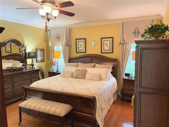 9849 Aspen Cir, Daphne, AL 36527 - bedroom featuring ornamental molding, multiple windows, light wood-style flooring, and ceiling fan