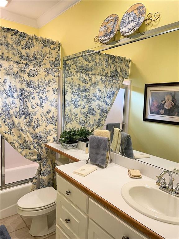 9849 Aspen Cir, Daphne, AL 36527 - full bathroom with ornamental molding, shower / bath combo with shower curtain, vanity, and tile patterned floors
