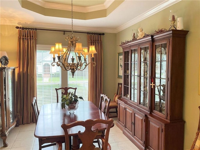 9849 Aspen Cir, Daphne, AL 36527 - dining room with light tile patterned floors, a chandelier, a tray ceiling, and crown molding