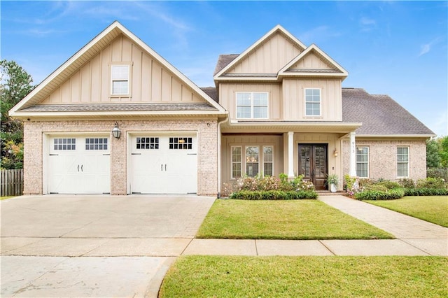 craftsman-style house with brick siding, a front lawn, board and batten siding, and concrete driveway