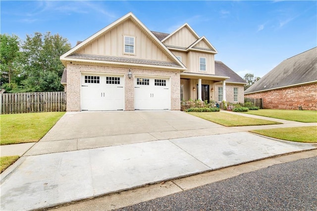craftsman-style house with a garage, fence, board and batten siding, and a front yard