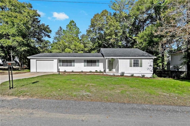 ranch-style house featuring a front lawn and a garage